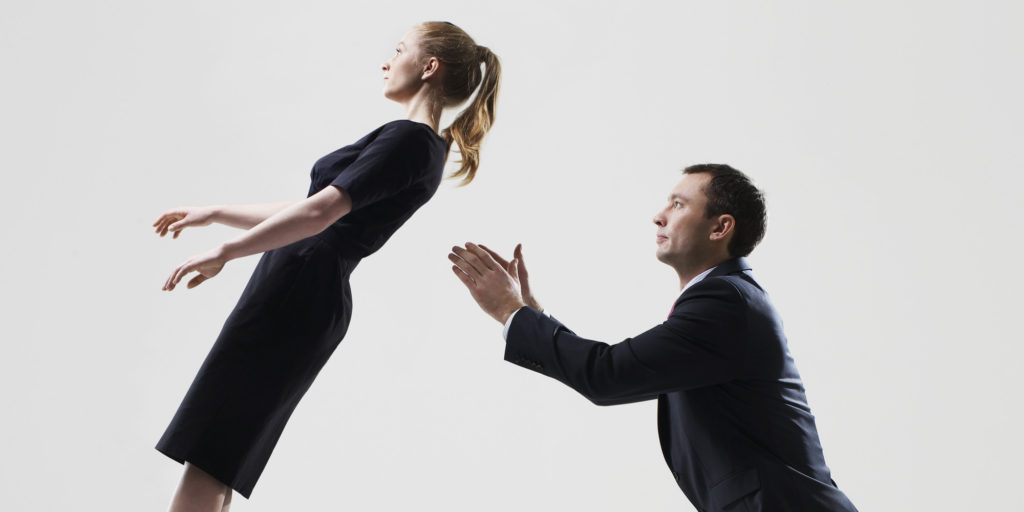 Businessman catching businesswoman
