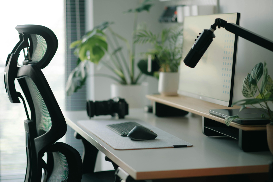 Workspace set up with ergonomic chair and Mouse, and elevated screen for comfort