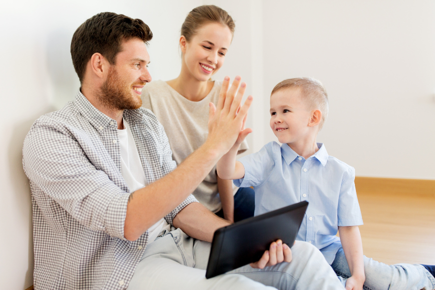 A family (diverse ages) engaged in a discussion around a tablet