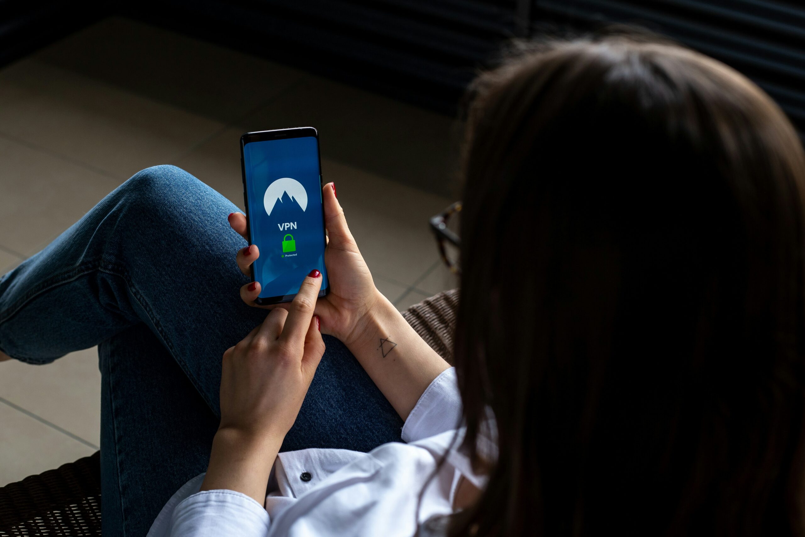 A woman with her phone setting it up with Virtual Private Networks (VPNs)