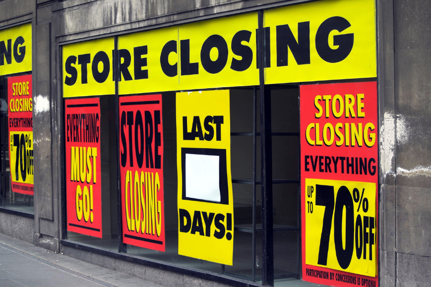 Image of a urban retail store with "Store Closing" signs.